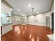 Bright living room with hardwood floors, ceiling fan and natural light streaming in through the windows at 8045 Waterbury Way, Mount Dora, FL 32757