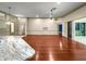 Spacious living room with hardwood floors, ceiling fan and sliding glass door leading to a patio at 8045 Waterbury Way, Mount Dora, FL 32757