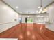 Open-concept living room boasts hardwood floors and abundant natural light at 8045 Waterbury Way, Mount Dora, FL 32757