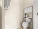 Small toilet room featuring a toilet and a cabinet at 8045 Waterbury Way, Mount Dora, FL 32757