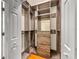 Walk-in closet with custom shelving and drawers, offering ample storage space at 8045 Waterbury Way, Mount Dora, FL 32757