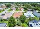 Aerial view showcasing a neighborhood with lush landscaping, mature trees, and well-maintained homes at 8960 Se 178Th Muirfield Pl, The Villages, FL 32162