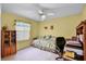 Bright bedroom featuring a daybed, desk, and floral accents, ideal for a or guest at 8960 Se 178Th Muirfield Pl, The Villages, FL 32162