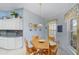 Cozy breakfast nook adjacent to the kitchen with a large window and wood table at 8960 Se 178Th Muirfield Pl, The Villages, FL 32162
