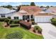 Attractive single-story home with a lush front lawn and brick-paved driveway at 8960 Se 178Th Muirfield Pl, The Villages, FL 32162
