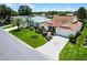 Beautiful house with a manicured lawn, palm tree, and brick-paved driveway at 8960 Se 178Th Muirfield Pl, The Villages, FL 32162