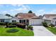 Charming single-story home featuring a well-manicured lawn and a neatly paved driveway at 8960 Se 178Th Muirfield Pl, The Villages, FL 32162