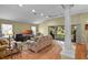 Spacious living area with a ceiling fan, hardwood floors, and a large sliding door to the outside at 8960 Se 178Th Muirfield Pl, The Villages, FL 32162