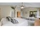 Cozy bedroom with a ceiling fan, sliding door access to the porch and closet space at 8960 Se 178Th Muirfield Pl, The Villages, FL 32162