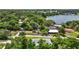 Aerial view showcasing lush trees surrounding homes and a body of water off in the distance at 902 Lakeview Dr, Eustis, FL 32726