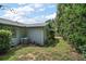 Side yard with green grass and an AC unit attached to the side of the house near a stepping stone path at 902 Lakeview Dr, Eustis, FL 32726