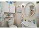 Cozy bathroom with coastal decor featuring a toilet, sink, and storage cabinet at 902 Lakeview Dr, Eustis, FL 32726