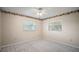 Comfortable bedroom with neutral walls, carpet, crown molding, and ample natural light from two windows at 902 Lakeview Dr, Eustis, FL 32726