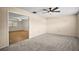 Bedroom with neutral paint, ceiling fan, and carpeted floors leading into another room with hardwood floors at 902 Lakeview Dr, Eustis, FL 32726