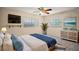 Comfortable bedroom with natural light, a ceiling fan, and ample storage at 902 Lakeview Dr, Eustis, FL 32726