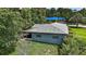 Exterior view of the home showcasing the roof, paint, back yard, and trees at 902 Lakeview Dr, Eustis, FL 32726