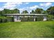 Charming single-story home featuring a well-maintained lawn and carefully trimmed hedges at 902 Lakeview Dr, Eustis, FL 32726