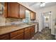 Beautiful kitchen features granite countertops, tile backsplash, dark wood cabinets, and stainless steel sink at 902 Lakeview Dr, Eustis, FL 32726