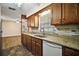 Charming kitchen with wood cabinets, granite countertops, tile backsplash, and stainless steel appliances at 902 Lakeview Dr, Eustis, FL 32726