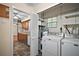 Open laundry room with full-sized washer and dryer, shelving, and access to the kitchen at 902 Lakeview Dr, Eustis, FL 32726