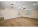 Light-filled living room boasts wood flooring, a ceiling fan, and an exterior door at 902 Lakeview Dr, Eustis, FL 32726