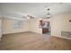 Spacious living room with hardwood floors flowing into a kitchen with wood cabinets at 902 Lakeview Dr, Eustis, FL 32726