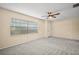 Living room with large window, ceiling fan, light colored walls, and carpeted floors at 902 Lakeview Dr, Eustis, FL 32726