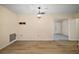 Well-lit living room features wood flooring and access to other rooms at 902 Lakeview Dr, Eustis, FL 32726