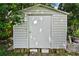 Exterior view of the white backyard storage shed with a simple door and horizontal siding at 902 Lakeview Dr, Eustis, FL 32726