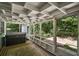Enclosed sun room with a hot tub, outdoor view, and patterned rug at 902 Lakeview Dr, Eustis, FL 32726