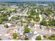 Aerial view of a neighborhood with mature trees, well-manicured lawns and several community pools at 910 Rangeline Rd, Longwood, FL 32750