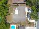 Aerial view of home highlighting the roof and backyard with a wooden deck and mature trees at 910 Rangeline Rd, Longwood, FL 32750