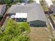 Aerial view of the house with a spacious backyard, a deck, and a privacy fence at 910 Rangeline Rd, Longwood, FL 32750