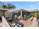 A spacious wooden deck features patio furniture and potted plants with view to the sun room at 910 Rangeline Rd, Longwood, FL 32750