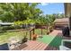 Backyard with wood deck, trees, lawn, and wooden fence for privacy at 910 Rangeline Rd, Longwood, FL 32750