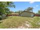 A spacious backyard featuring a well-maintained lawn and a shed with outdoor seating at 910 Rangeline Rd, Longwood, FL 32750