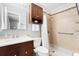 This renovated bathroom has modern fixtures and a walk-in shower with ceramic tiles, built-in shelving, and grab bars at 910 Rangeline Rd, Longwood, FL 32750