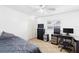 This cozy bedroom has a ceiling fan, a built-in closet, and a dedicated workspace for optimal comfort and productivity at 910 Rangeline Rd, Longwood, FL 32750