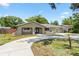 Charming single-story home featuring a well-manicured front lawn and a freshly poured circular concrete driveway at 910 Rangeline Rd, Longwood, FL 32750
