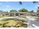 Charming single-story home featuring a well-manicured front lawn and a freshly poured concrete driveway at 910 Rangeline Rd, Longwood, FL 32750