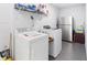 Enjoy the convenience of a dedicated laundry room with ample shelving and storage for cleaning supplies and laundry essentials at 910 Rangeline Rd, Longwood, FL 32750