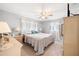 Serene primary bedroom featuring soft lighting, neutral tones, and comfortable furniture, creating a tranquil retreat at 910 Rangeline Rd, Longwood, FL 32750