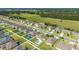 An aerial view displays the community homes, green spaces, and neighborhood layout at 9785 Pepper Tree Trl, Wildwood, FL 34785