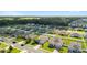 A neighborhood aerial view shows a community featuring well-maintained homes and green lawns at 9785 Pepper Tree Trl, Wildwood, FL 34785
