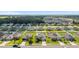 Aerial view of homes in a well-planned neighborhood with lush landscaping and community amenities at 9785 Pepper Tree Trl, Wildwood, FL 34785