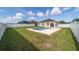 Spacious backyard with a refreshing pool, white privacy fence, and lush green lawn at 9785 Pepper Tree Trl, Wildwood, FL 34785