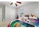Inviting bedroom with a ceiling fan, window and a cozy ambiance, ideal for restful nights and relaxation at 9785 Pepper Tree Trl, Wildwood, FL 34785