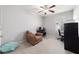 Versatile bedroom featuring an armchair and desks, easily convertible into a home office for work or relaxation at 9785 Pepper Tree Trl, Wildwood, FL 34785