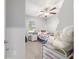 Bright bedroom with a ceiling fan, a window, and a comfortable ambiance, perfect for relaxation at 9785 Pepper Tree Trl, Wildwood, FL 34785