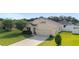 Charming single-Gathering home with a well-manicured lawn, two-car garage, and inviting curb appeal at 9785 Pepper Tree Trl, Wildwood, FL 34785